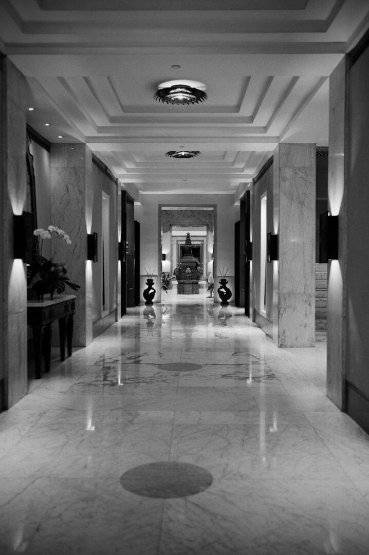 a very long hallway with a bunch of lights on the ceiling